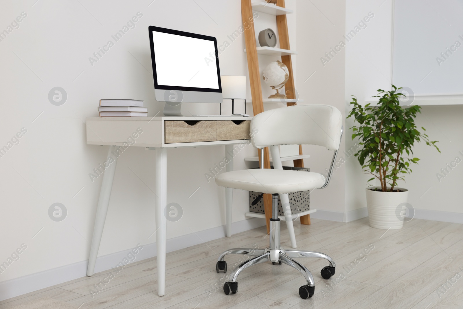 Photo of Workplace with comfortable office chair indoors. Interior design