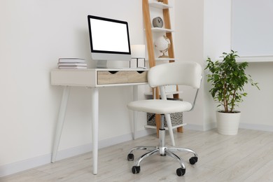 Workplace with comfortable office chair indoors. Interior design