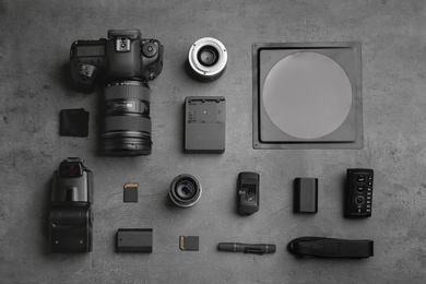 Photo of Flat lay composition with photographer's equipment and accessories on grey background