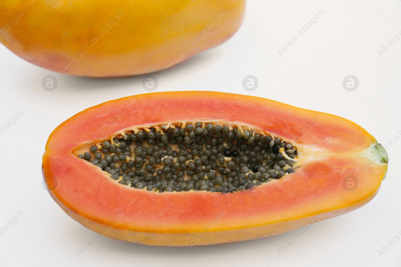 Photo of Half of fresh ripe papaya fruit on white background