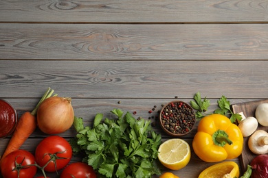 Flat lay composition with ingredients for cooking on wooden table. Space for text