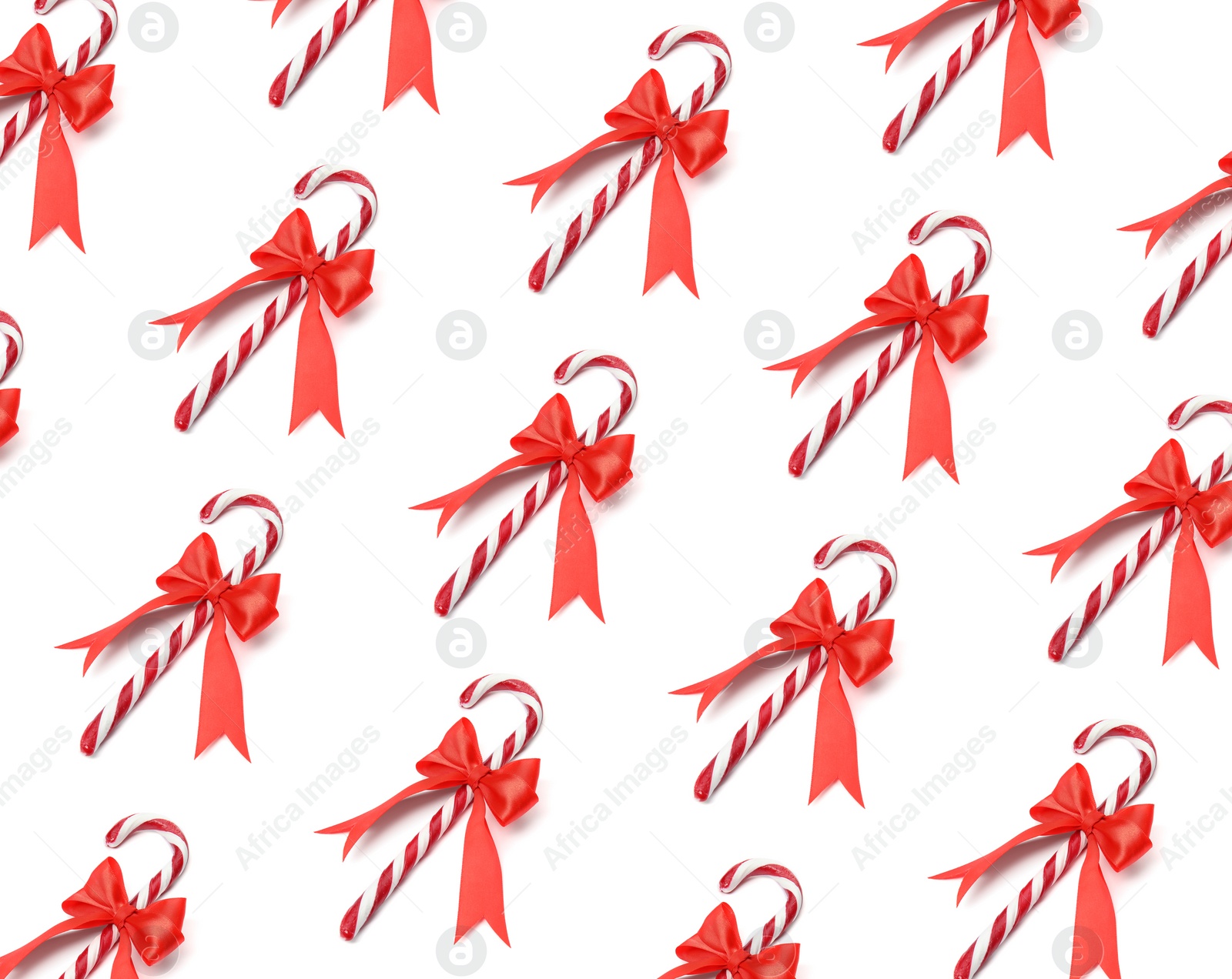 Image of Tasty Christmas candy canes on white background. Pattern design