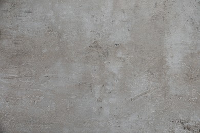 Texture of light grey stone surface as background, closeup