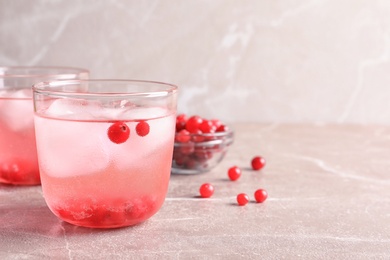 Refreshing tasty natural lemonade with ice on table