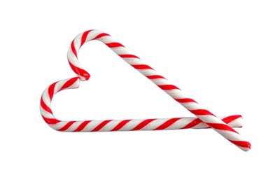 Photo of Candy canes on white background, top view. Traditional Christmas treat
