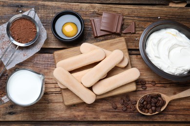 Photo of Flat lay composition with ingredients for tiramisu on wooden table