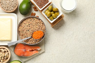 Photo of Different products high in natural fats on light table, flat lay. Space for text