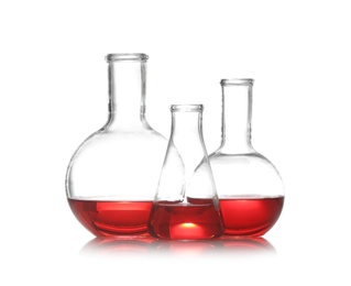 Group of chemistry glassware with liquid samples isolated on white
