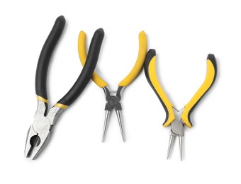 Photo of Group of different pliers isolated on white, top view