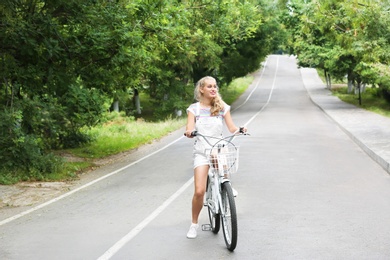 Beautiful woman in casual outfit with bicycle outdoors