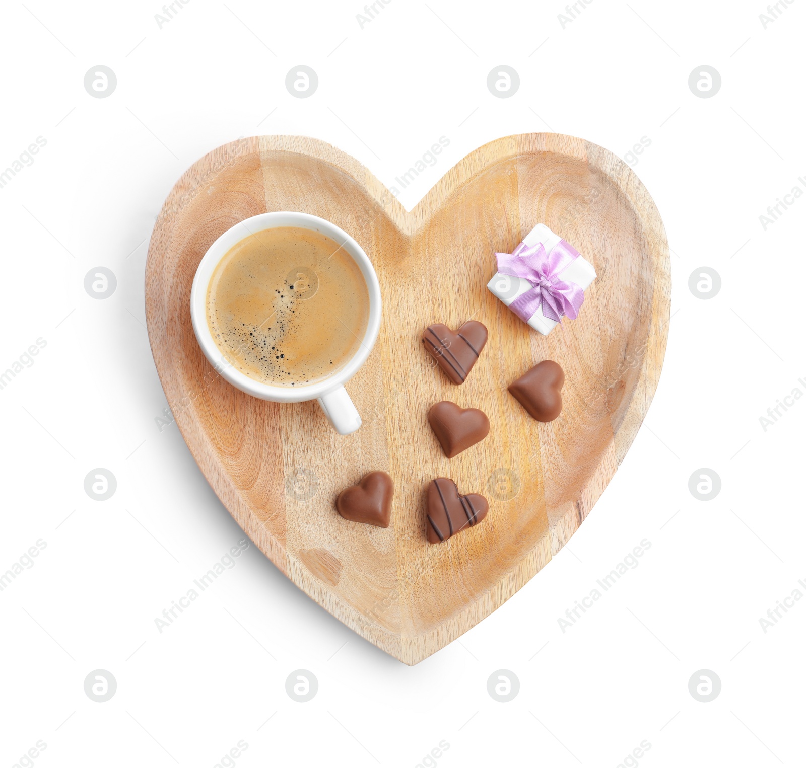 Photo of Romantic breakfast with cup of coffee, chocolate candies and gift box isolated on white, top view. Valentine's day celebration