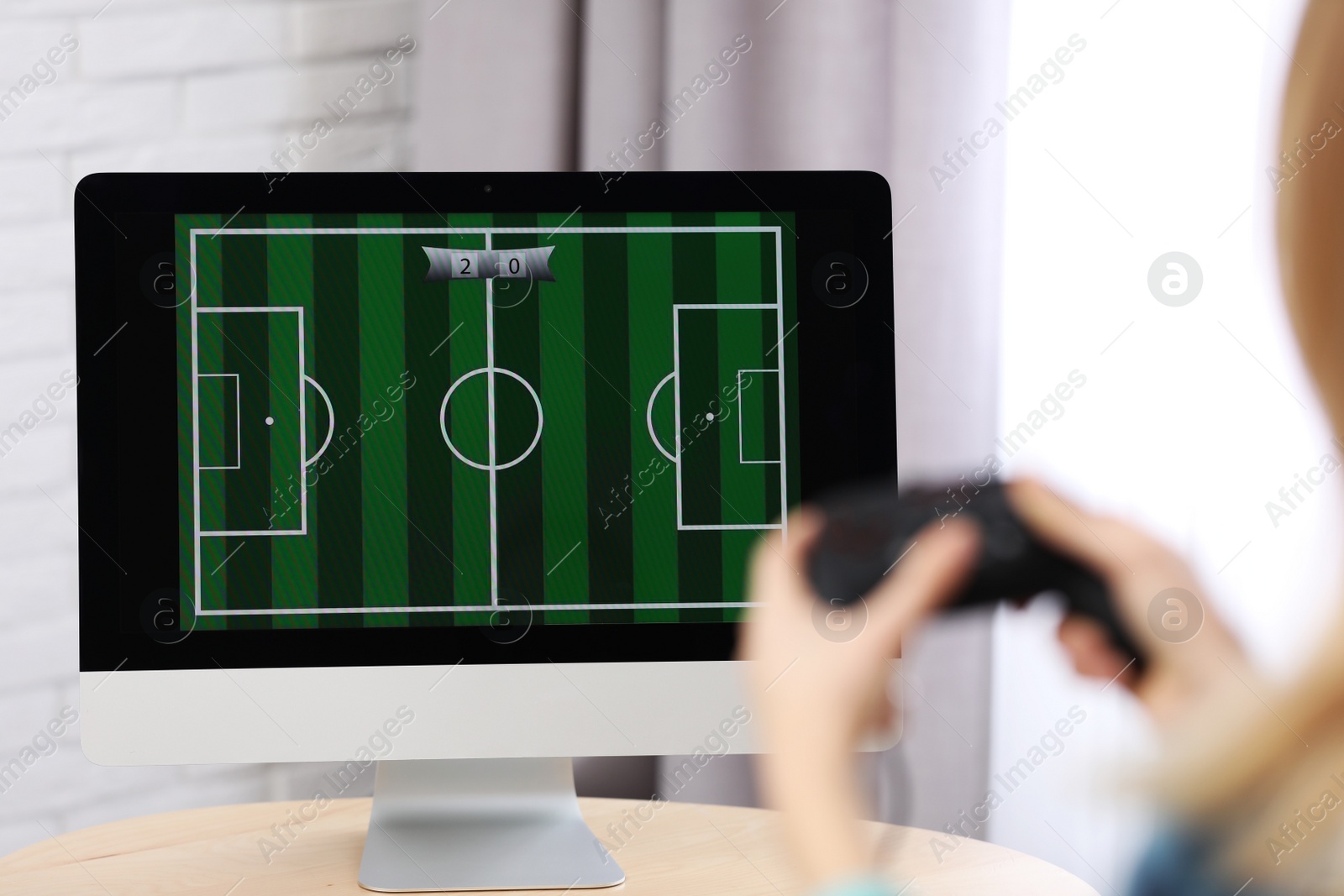 Photo of Young woman playing video game at home, closeup