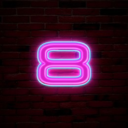 Image of Glowing neon number 8 sign on brick wall