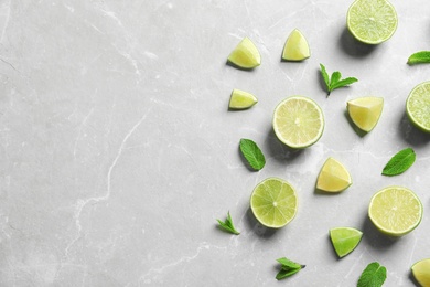Photo of Composition with fresh ripe limes on light background, top view