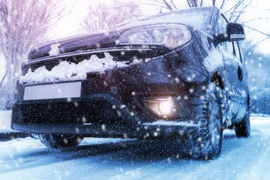 Image of Modern car with winter tires on snowy road