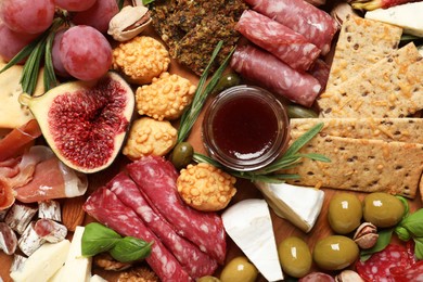 Photo of Different tasty appetizers as background, top view