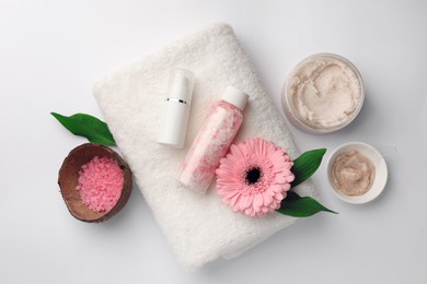 Flat lay composition with different spa products and beautiful flower on white table