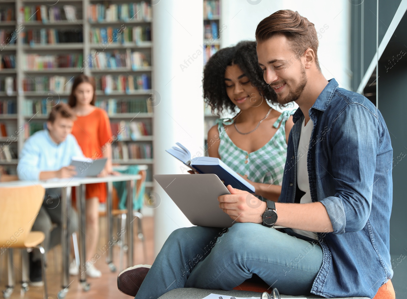 Photo of Young people studying together in modern library