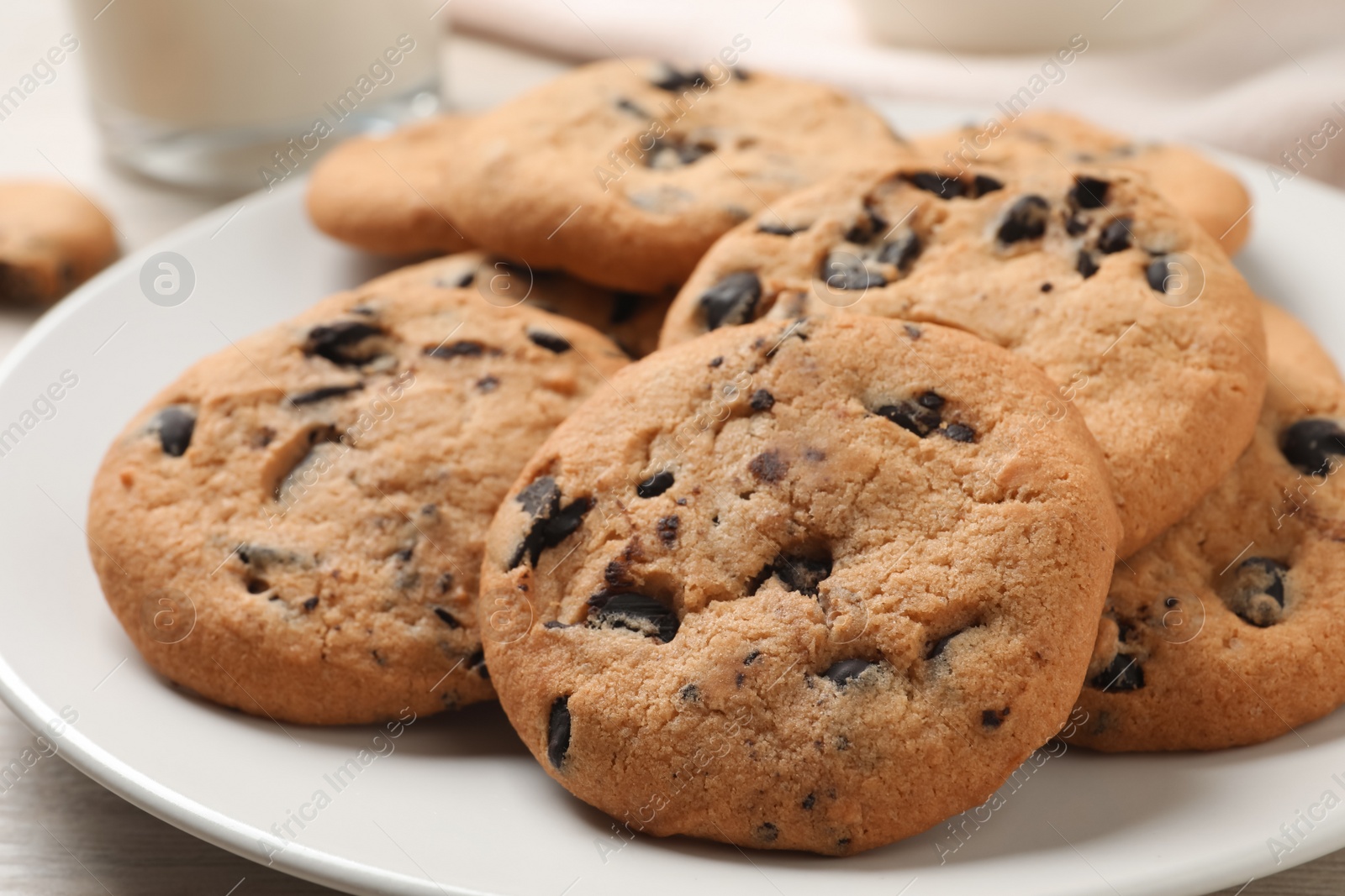 Photo of Delicious chocolate chip cookies on plate, closeup