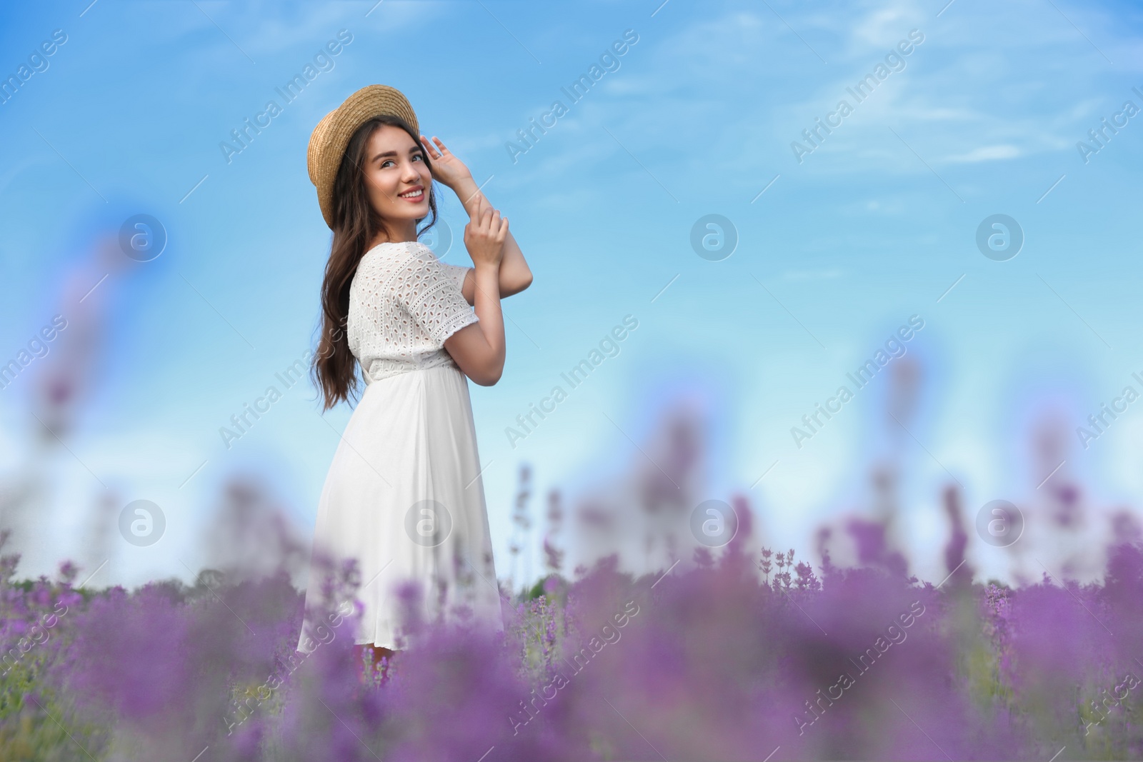 Photo of Young woman in lavender field on summer day