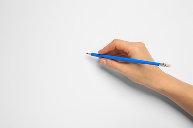 Woman with new graphite pencil on white background, closeup. Space for text