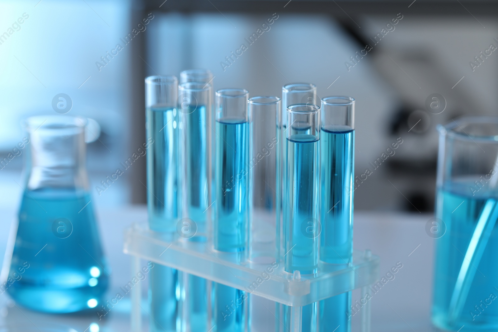 Photo of Test tubes with light blue liquid in laboratory, closeup