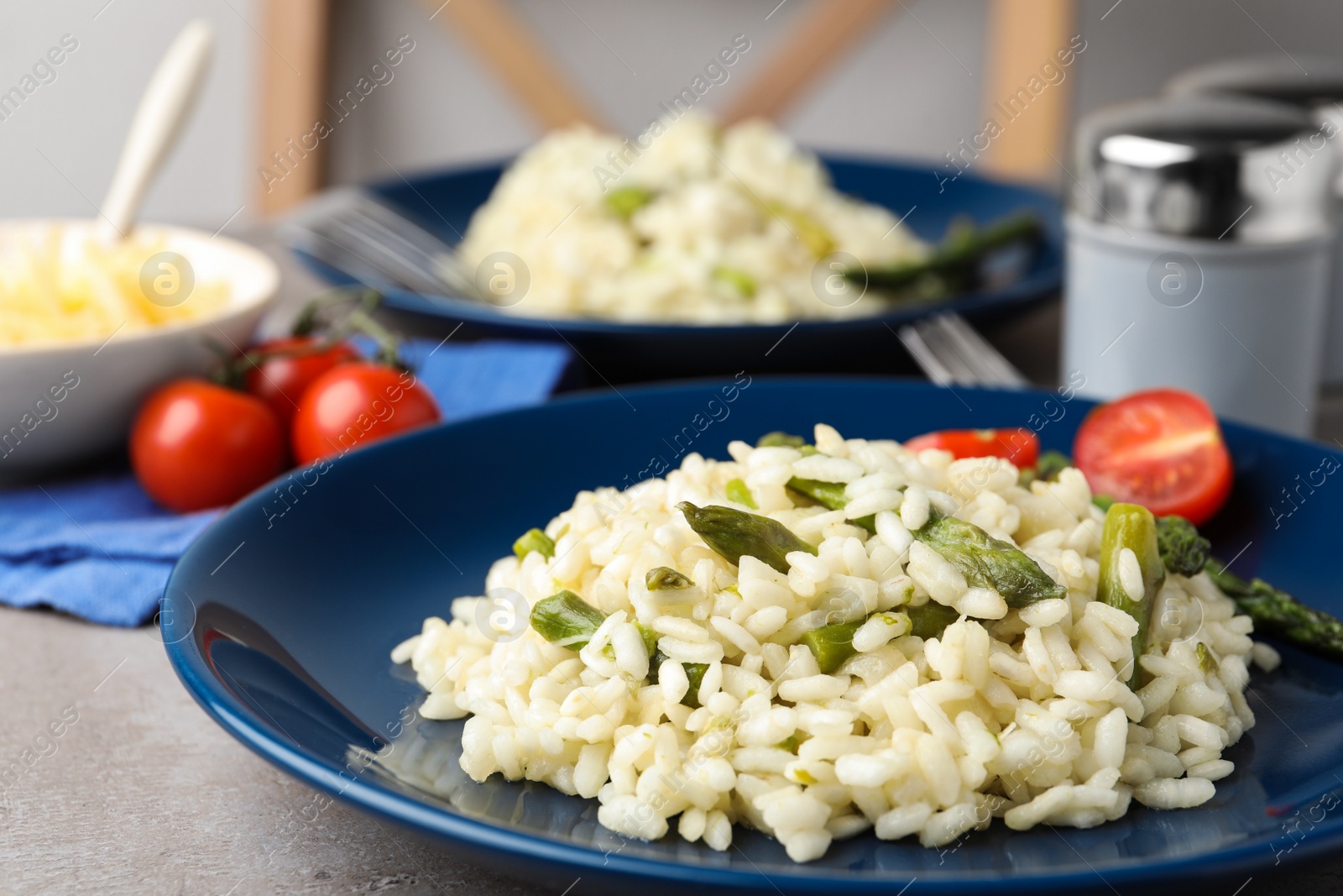 Photo of Delicious risotto with asparagus in plate, closeup