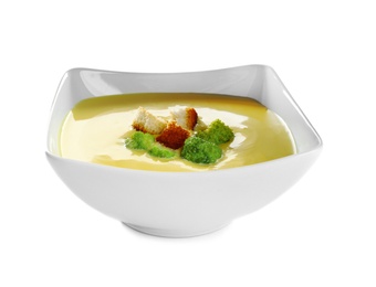 Bowl of cheese cream soup with broccoli and croutons on white background