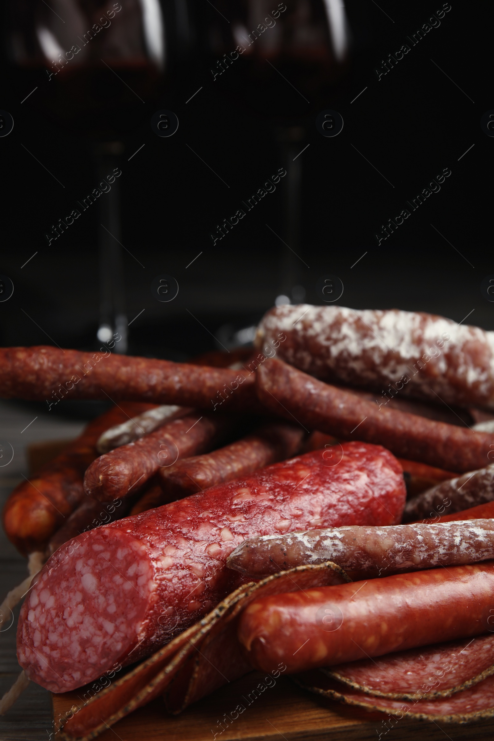 Photo of Different tasty sausages on wooden table, closeup