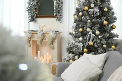 Photo of Decorated Christmas tree in modern living room interior