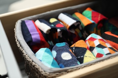 Photo of Chest of drawers with different socks, closeup