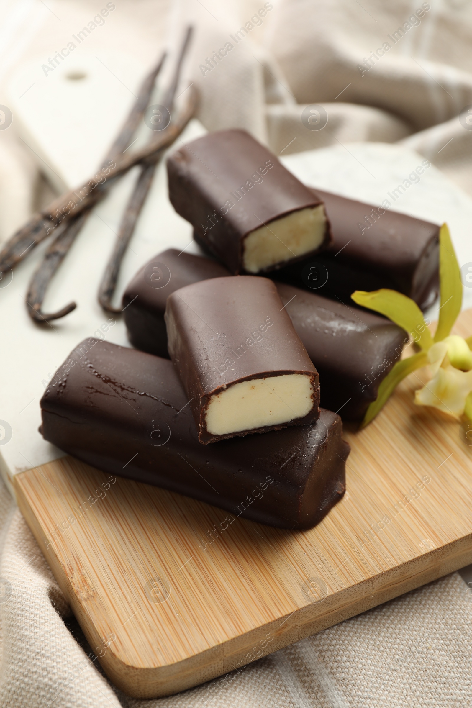 Photo of Glazed vanilla curd cheese bars on table, closeup