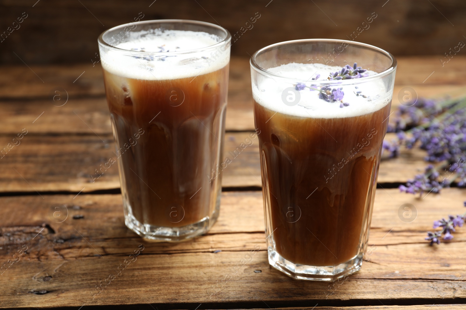 Photo of Delicious coffee with lavender on wooden table