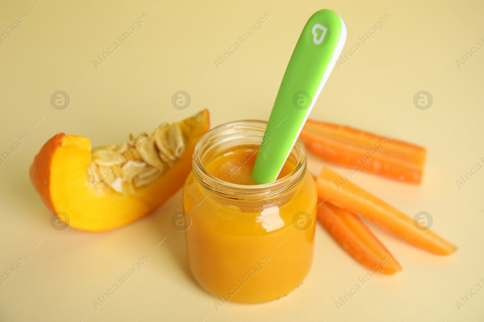 Photo of Healthy baby food and ingredients on beige background