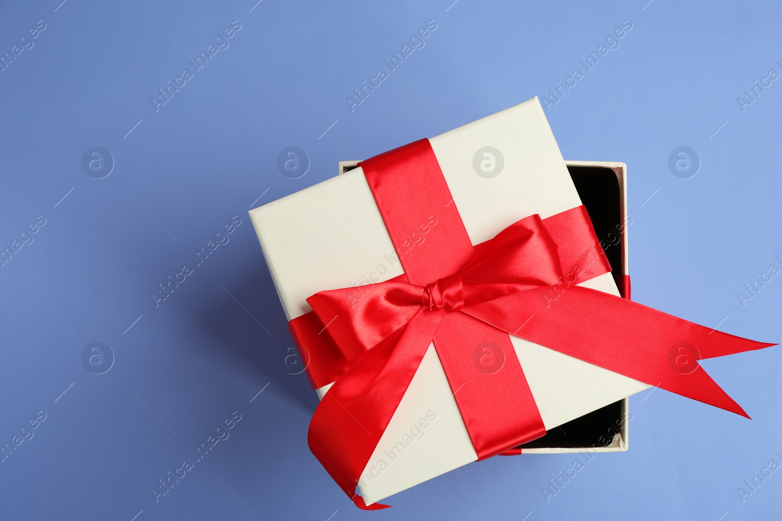 Photo of Beautifully decorated gift box on color background, top view