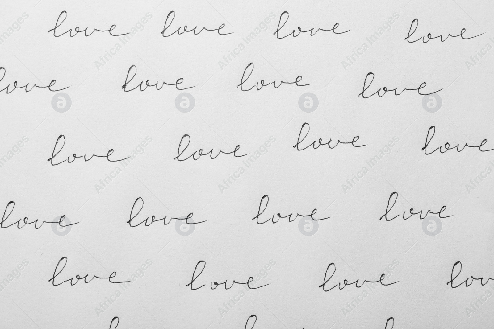 Photo of Word LOVE written multiple times on white background, top view