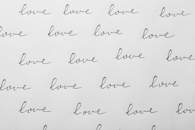 Photo of Word LOVE written multiple times on white background, top view