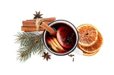 Photo of Mug of mulled wine, cinnamon, orange and fir branch on white background, top view