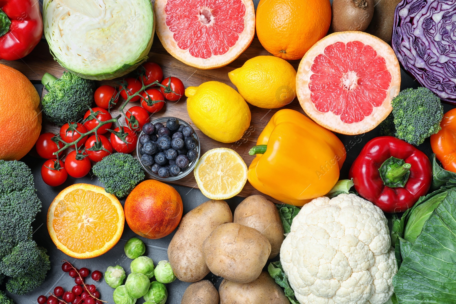 Photo of Different products rich in vitamin C on table, flat lay