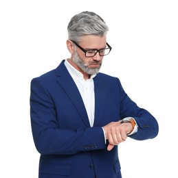 Mature businessman in stylish clothes checking time on white background