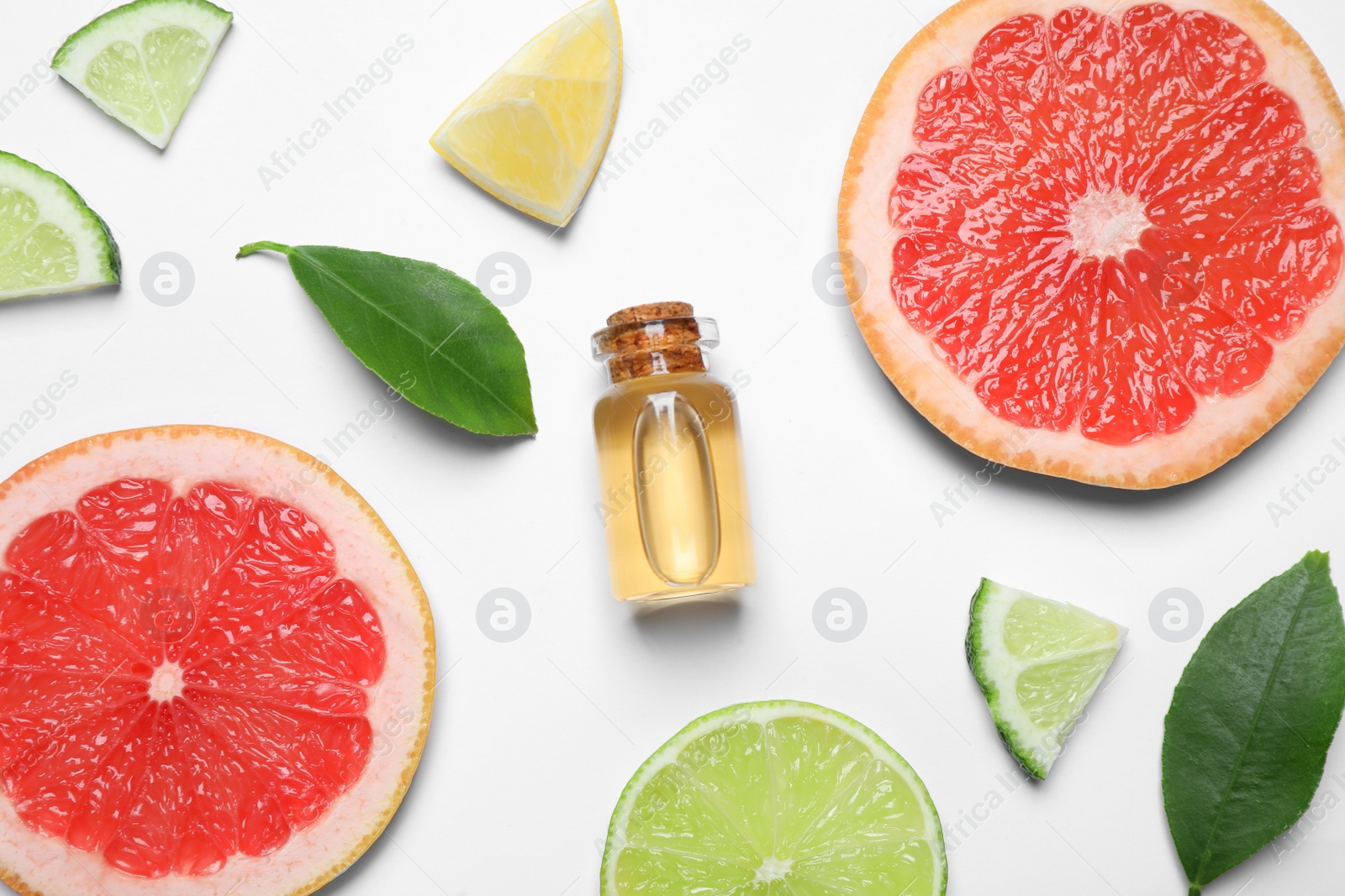 Photo of Flat lay composition with bottle of citrus essential oil on white background