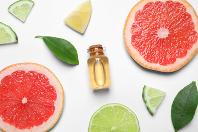 Photo of Flat lay composition with bottle of citrus essential oil on white background