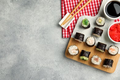 Photo of Flat lay composition with sushi rolls on grey table. Space for text