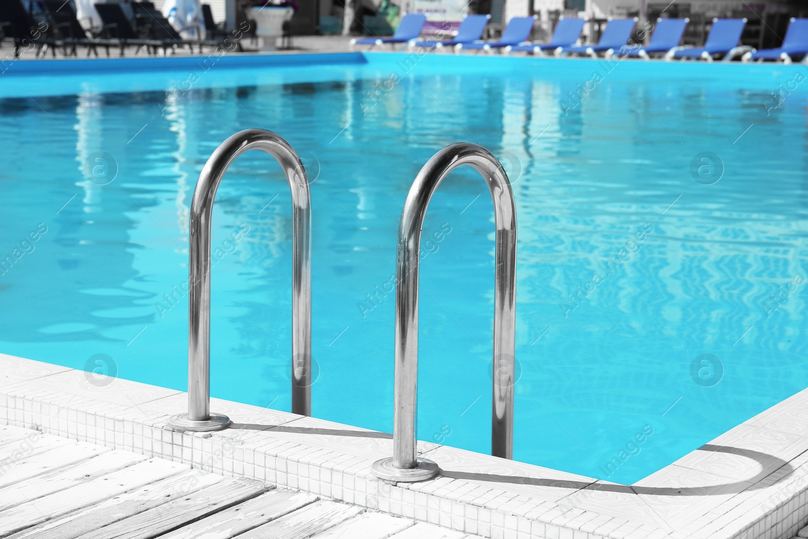 Photo of Modern swimming pool with step ladder outdoors