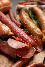 Different tasty sausages on table, closeup view