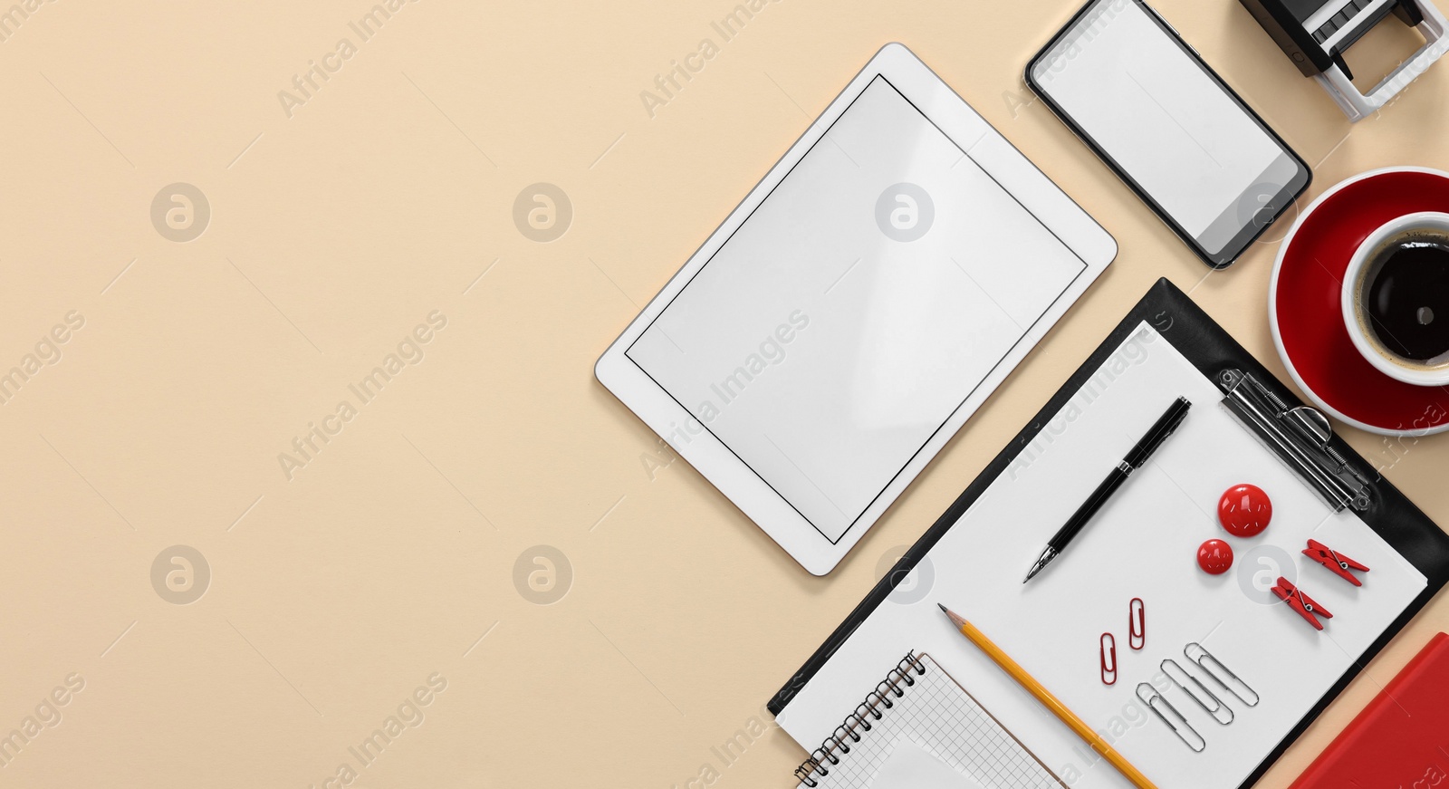 Photo of Modern tablet, smartphone, stationery and coffee on beige background, flat lay. Space for text