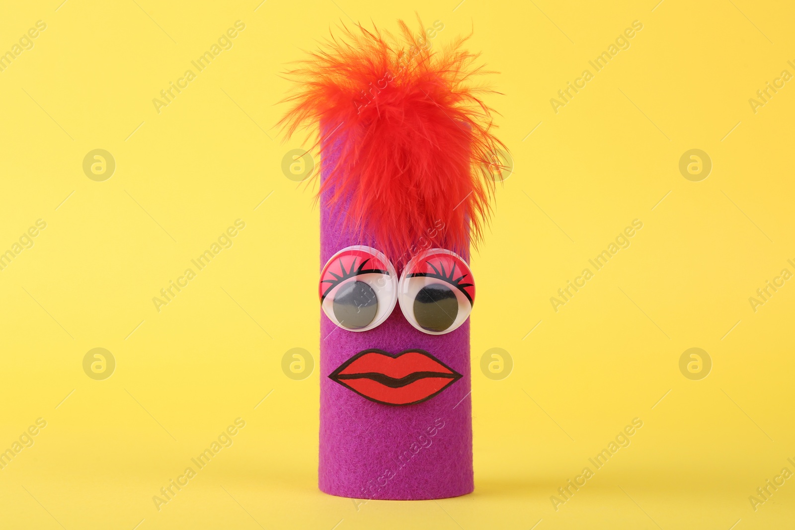 Photo of Purple monster on yellow background. Halloween decoration