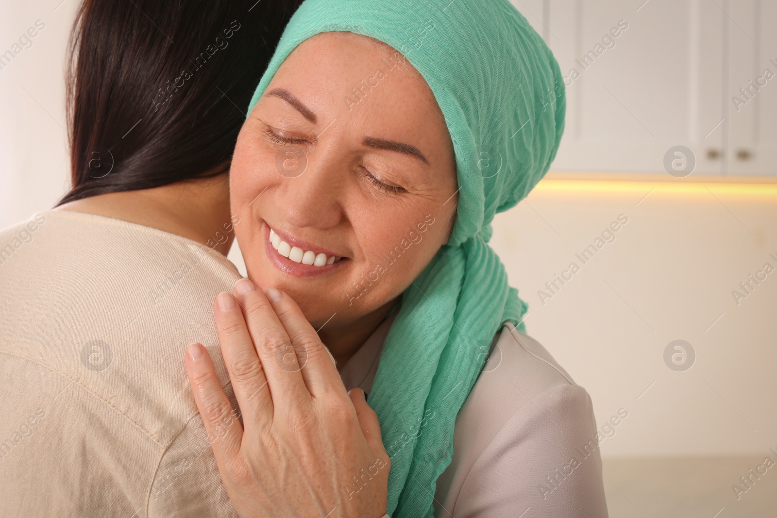 Photo of Young woman visiting her mother with cancer indoors