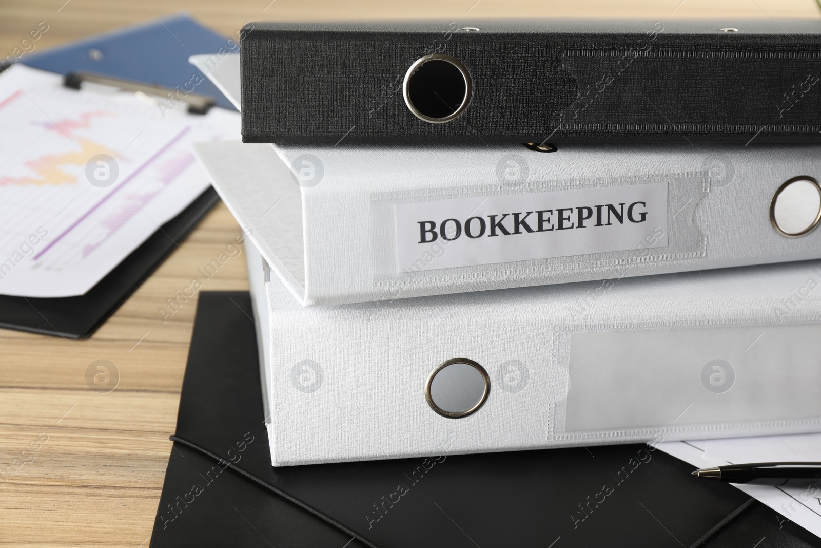 Photo of Stack of folders on desk in office. Bookkeeper's workplace