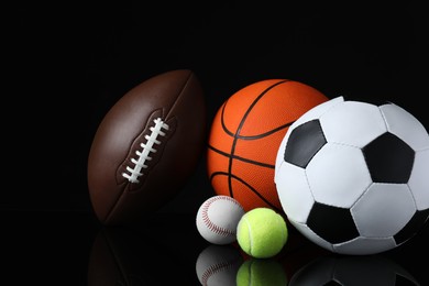 Photo of Set of different sport balls on black mirror surface